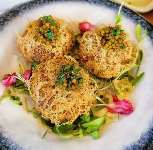 Golden taro puffs topped with kaluga caviar and microgreens at a Bay Area restaurant, an Instagram-worthy dish that drives saves and shares