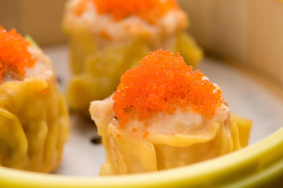 Close-up of shrimp and pork siu mai topped with bright orange crab roe at a Bay Area dim sum restaurant, the kind of scroll-stopping food photo that only works as hard as the caption written underneath it.