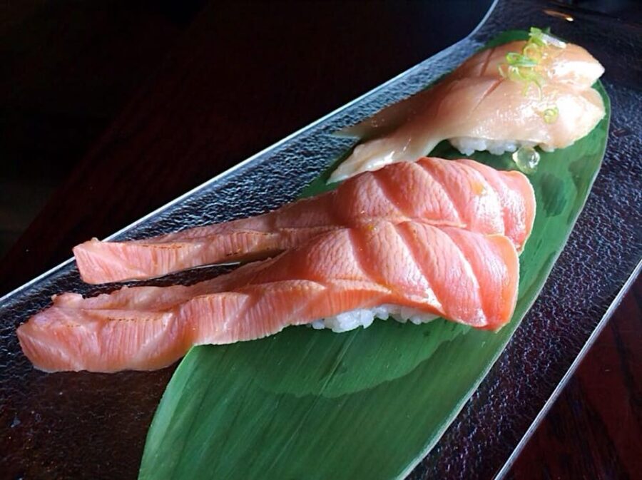 Seared sake toro and shiro maguro nigiri with yuzu crystals on a bamboo leaf, the kind of distinctive, well-told dish that helps a Bay Area restaurant stand apart once it has studied what its competitors post.