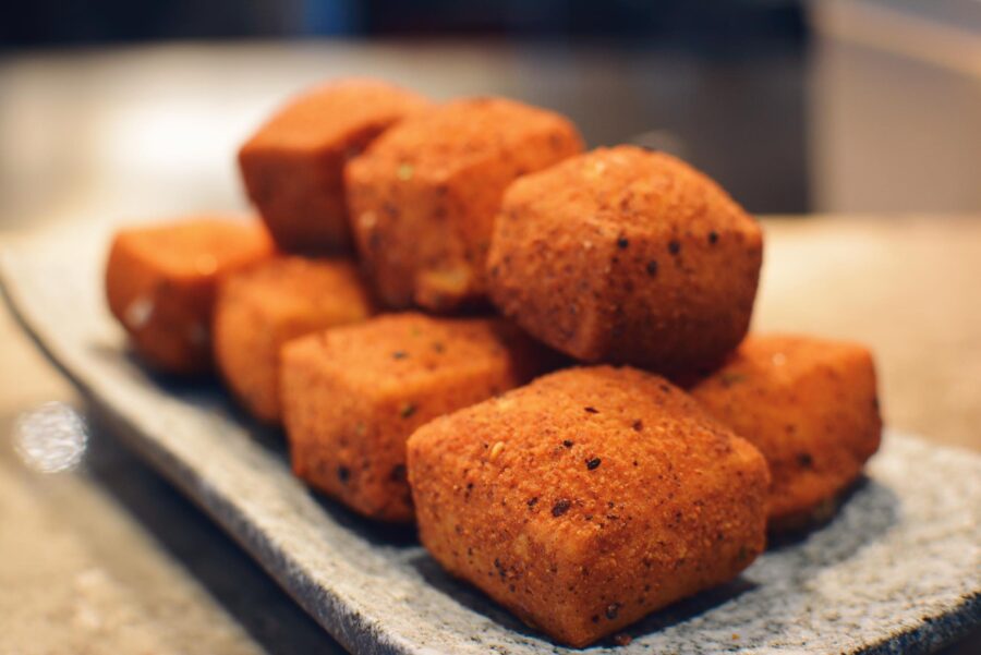 A stack of golden, seven-spice crispy silken tofu cubes on a slate plate at Palette Tea House in San Francisco, the kind of steady, well-made dish that builds goodwill a Bay Area restaurant can lean on when a social media crisis hits.